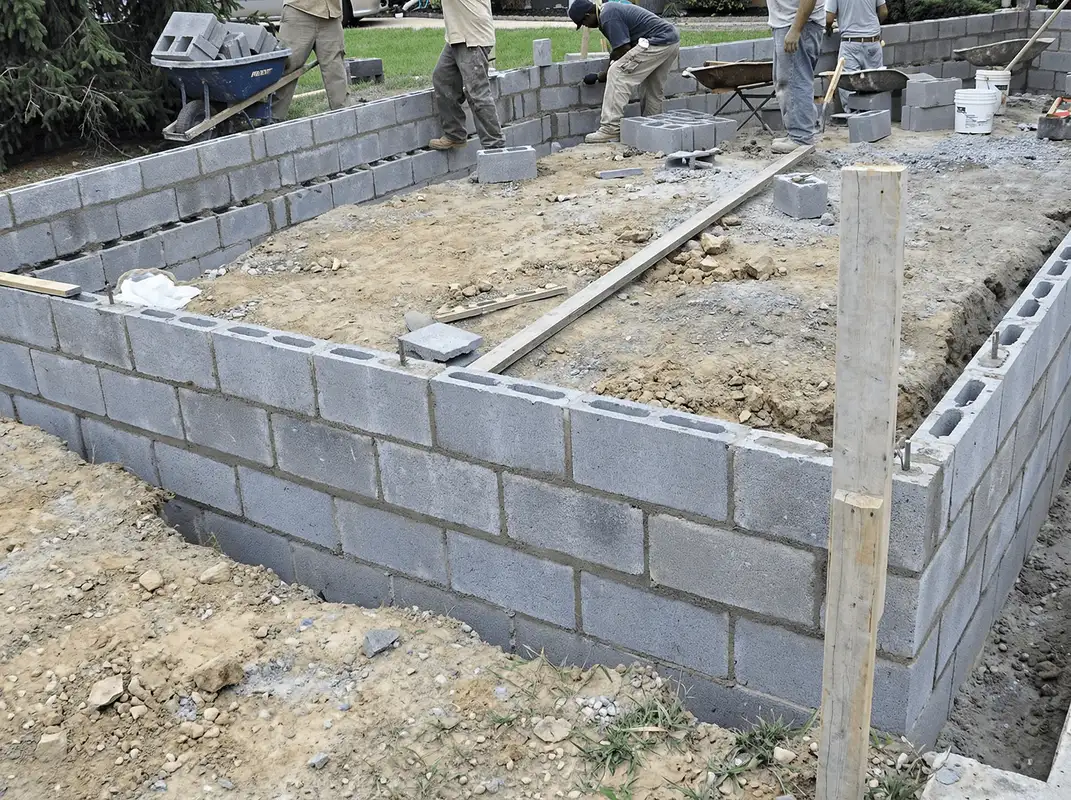 Professionals building a foundation with blocks in ,